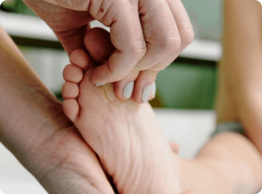 Podiatrist massaging the sole of a patient’s foot