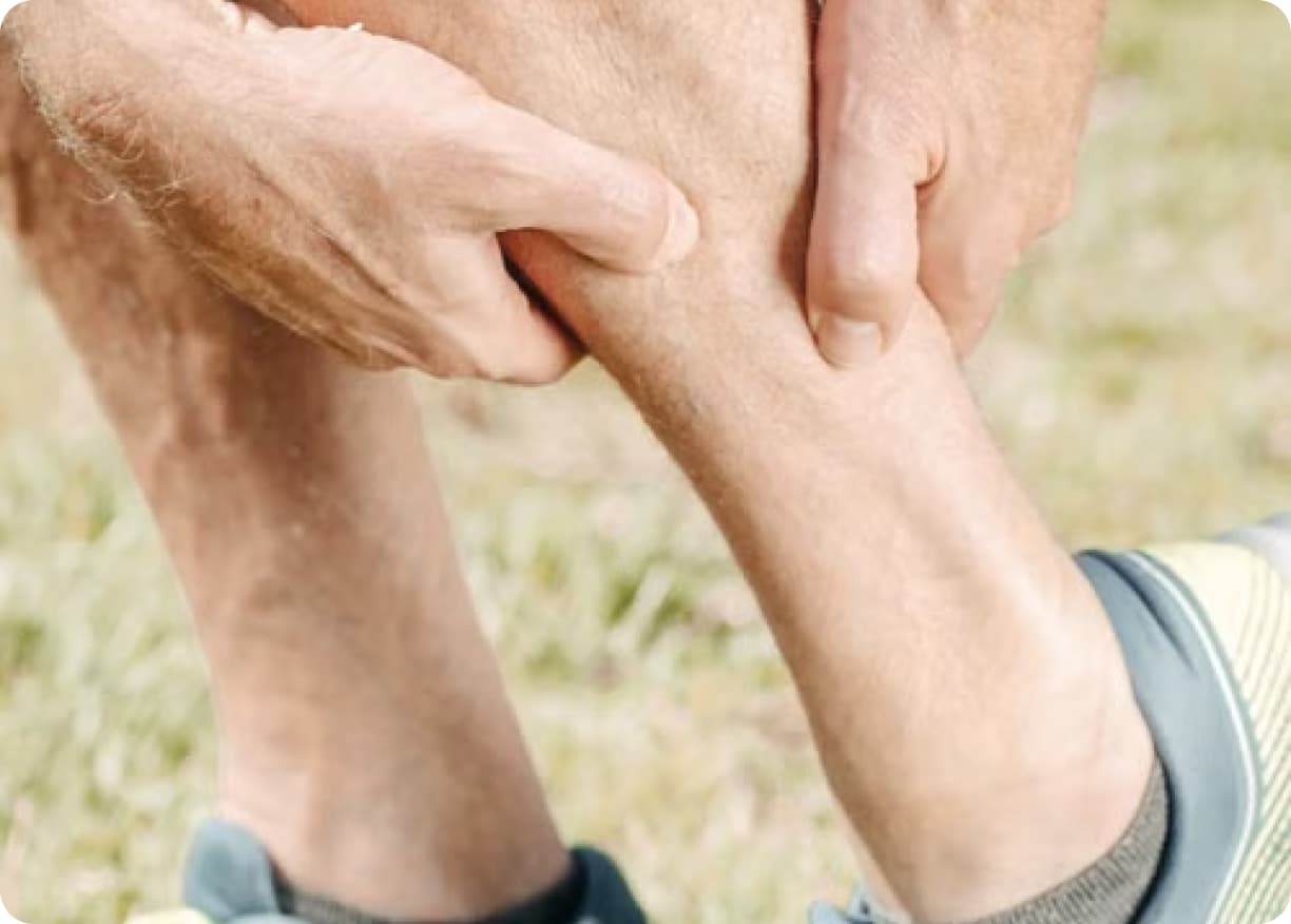 Runner holding their calf in pain