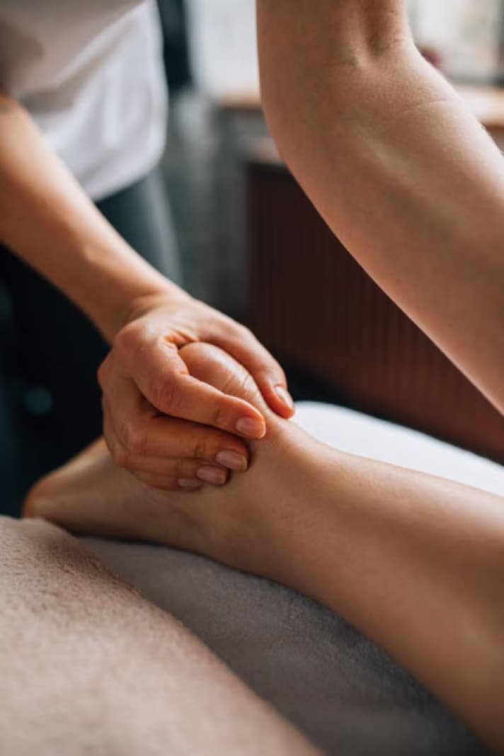 Podiatrist treating the back of a patient's lower leg