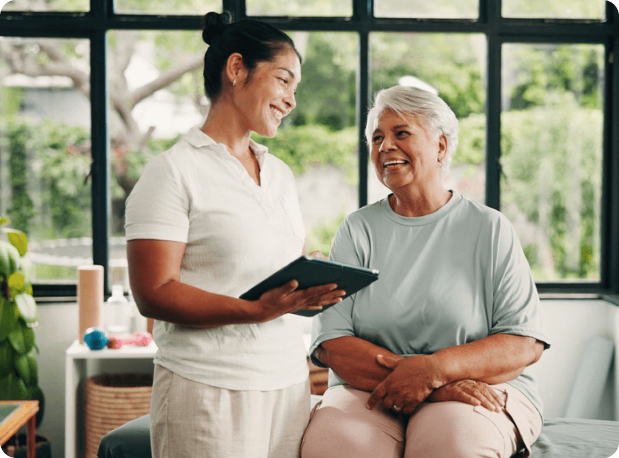 Podiatrist chatting with a smiling older patient