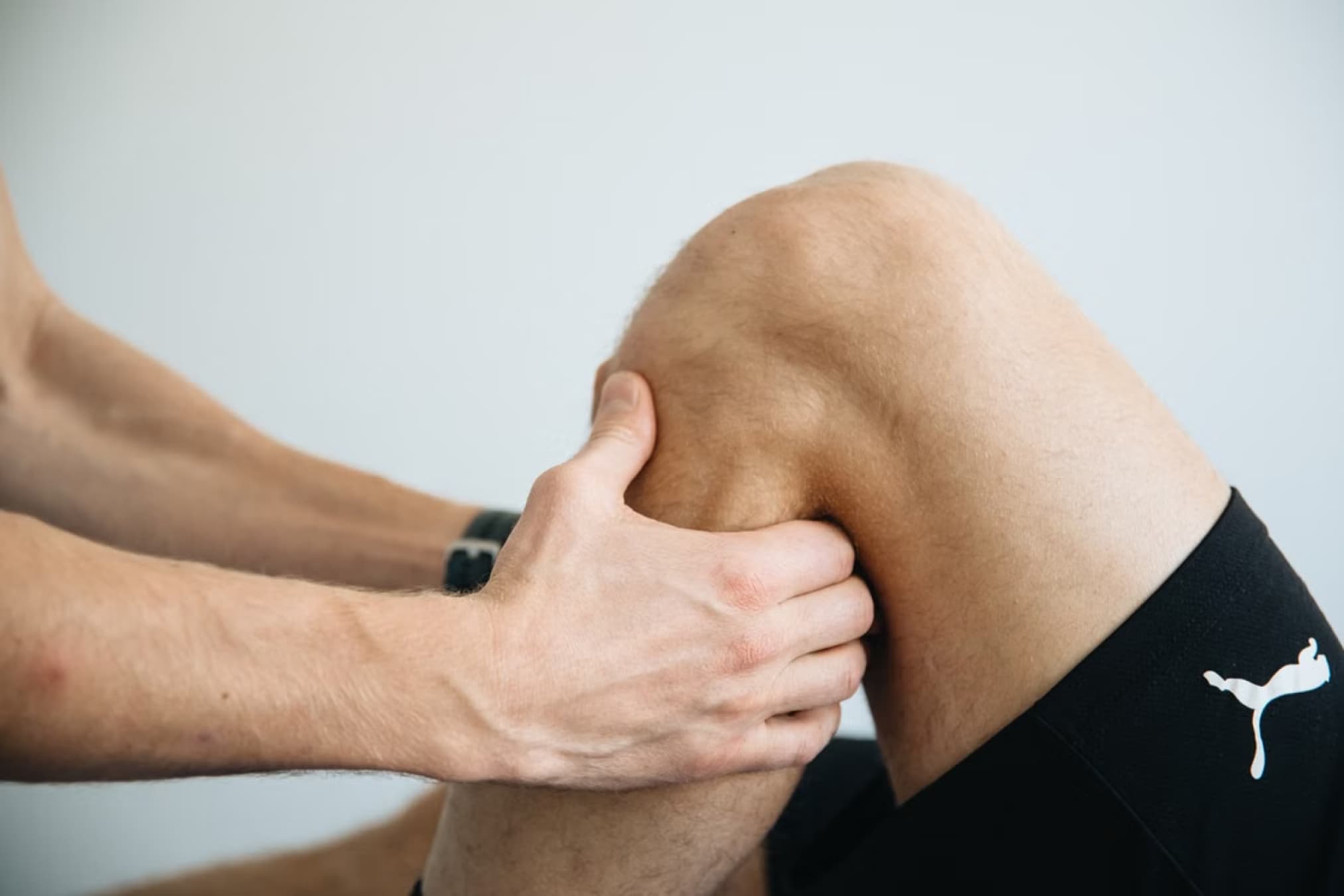 Podiatrist examining an athlete's knee and lower leg